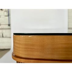 a close up view of the top of a wooden table with drawers in the background