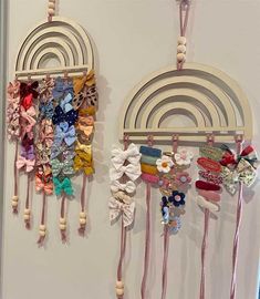 two wall hangings with hair clips attached to them