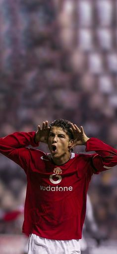 a soccer player holding his hands to his head