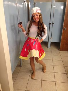 a girl in a costume holding a donut