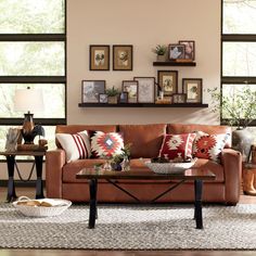 a living room filled with lots of furniture and pictures on the wall above it's coffee table