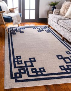 a living room with a couch, chair and rug