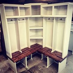 an empty room with white cabinets and wooden benches