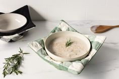 bowl of oats sitting inside the elm green bowl cozy displayed next to a sprig of tyme and wooden spoon and a white and gray marble surface Quilted Cozies, Candy Cocktails, Bowl Covers, Kitchenware Shop, Hot Cereal, Hot Dish, Bowl Cozy, Fabric Bowls, 9 Square