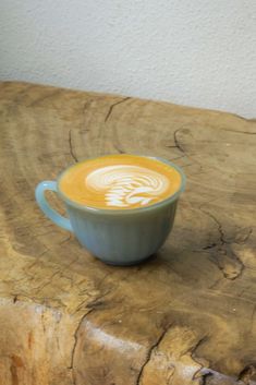 a coffee cup sitting on top of a wooden table