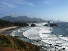 an ocean view with waves crashing on the shore