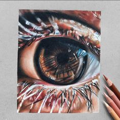 someone is drawing an eye with colored pencils