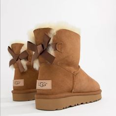 Brand New In Box Ugg Bailey Mini Bow Boots Ii. Size 9. Chestnut Brown Color. Perfect To Give As A Gift With Original Packaging And Box! Backed With A Ribbon Bow, The Bailey Bow Ii Boots From Ugg Are A Playful Take On Their Iconic Silhouette. Shaft Height: 6" Round-Toe Slip-On Boots Bow Detail At Back Water Resistant Suede And Stain Resistant Upper Pieced, Dyed Sheepskin Fur Upper 17 Mm Sheepskin Lining And Insole, And Treadlite Outsole For Comfort Sheepskin Upper; Wool Lining; Polyester Backi Platform Outfit, Ugg Platform, Ugg Boots With Bows, Brown Uggs, Cute Uggs, Chestnut Brown Color, Brown Ugg Boots, Ugg Ankle Boots, Uggs With Bows