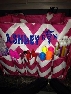 a pink and white chevroned bag with personalized items in the bottom pocket