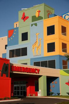 an emergency building painted in bright colors with giraffes on it