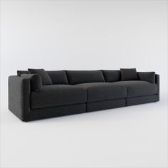 a black couch sitting on top of a white floor