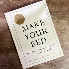 the book make your bed by william h harvey is laying on a wooden table top