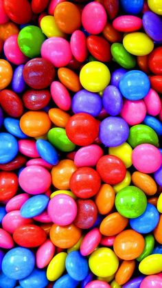 many different colored candies in a pile