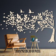 a tree with birds on it and the words mynkhome above it in front of a wall