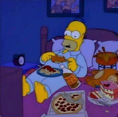 the simpsons is sitting in bed eating pizza