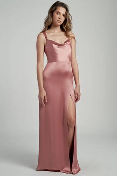 a woman in a long pink dress with a slit down the side and one leg