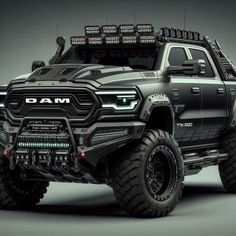 a black truck with large tires and lights on it's front end is shown