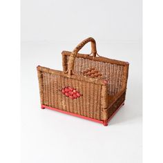 a wicker basket with red trim and handles