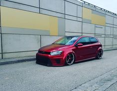 a red car parked on the side of a road