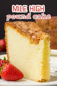 a close up of a slice of cake on a plate with strawberries in the background