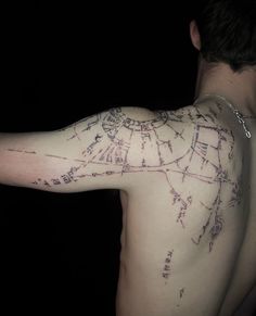 a man's arm with a map on it and writing all over the arm