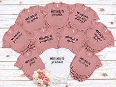 a bunch of pink onesuits with the words bride and groom printed on them