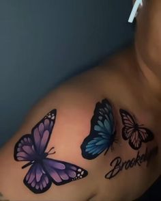 a woman with three butterflies on her chest