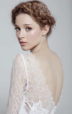 a woman wearing a wedding dress with an intricate headpiece