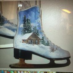 a pair of ice skates decorated with a winter scene