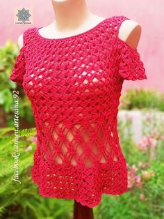 a crocheted top is shown on a mannequin headdress with flowers in the background