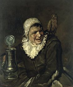 an old woman with a bird on her shoulder sitting in front of a silver vase