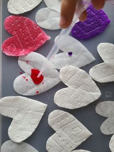 paper hearts being sewn together on a table