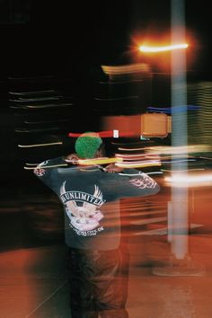 a skateboarder is standing on the sidewalk at night