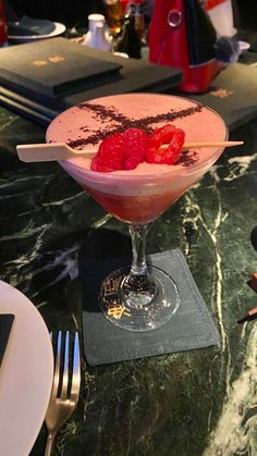 a dessert with strawberries in a glass on a table