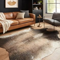 a living room with two couches and a rug on the floor in front of a window