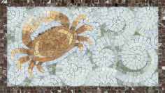 a crab is depicted on a mosaic tile wall in the shape of an ocean animal