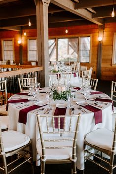 the tables are set with white and red linens