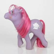 a toy pony with pink hair and a cupcake on it