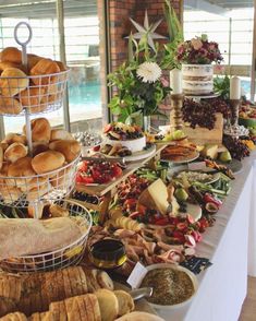 an assortment of breads and pastries on a buffet table