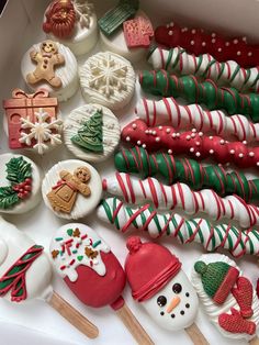 a box filled with lots of decorated cookies and marshmallows on top of each other