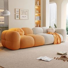 an orange and white couch sitting on top of a rug