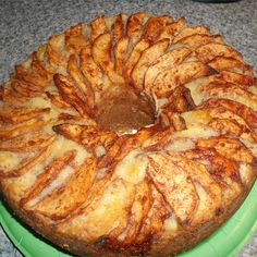 a bundt cake on a green plate sitting on a counter