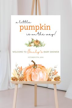 an easel with a pumpkin baby shower sign on it