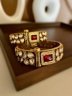 Kundan openable kada bracelet in Antique gold finish with ruby red stones. Rajwadi kada with premium quality gold foiled kundan from our Indian wedding collections. Create beautiful memory for any occasion with elegant jewelry for your loved ones You will receive carefully packaged items in jewelry box, ready to give memorable gift  to your Wife, mother, sister  friend or collegue. All orders will be shipped  out in 1 business day after receiving order. Plz do ensure correct address at checkout. Luxury Kundan Bangle For Ceremonial Occasions, Luxury Festive Bangle With Intricate Design, Elegant Openable Bracelets For Puja, Elegant Openable Bracelet For Puja, Hand Set Bracelets For Puja During Diwali, Traditional Openable Bracelets For Ceremonial Occasions, Openable Bracelet For Festive Occasions And Diwali, Traditional Openable Ceremonial Bracelets, Bollywood Hand Set Bangle For Puja