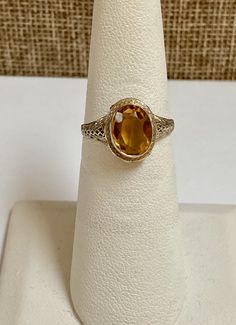 Welcome To Gold Knox Beautiful Art Deco 14k white gold ring featuring a genuine oval faceted citrine securely set in bezel on a filigree designed ring setting. This beautiful piece of jewelry featuring November's birthstone, would be a great gift for any occasion. Details Below: Material 14K white gold, yellow citrine Size 6 US Stone 8mm X 7mm (approximate 1.25 ct) Hallmark 14k This would make great addition to your vintage collection. Thank you for looking Gold Knox opened its storefront in Pas Oval Yellow Gold Filigree Ring With Gemstone, Oval Diamond Cut Filigree Ring, Formal Oval Topaz Ring With Filigree, Oval Topaz Ring With Filigree Detail, Elegant Oval Filigree Ring With Birthstone, Oval Topaz Ring With Filigree, Oval Filigree Ring With Birthstone For Anniversary, Oval Amber Topaz Ring For Formal Occasions, Formal Oval Amber Topaz Ring