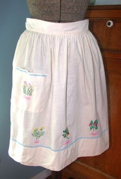 a woman's white skirt with flowers on it