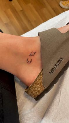 a woman's foot with a tattoo on it