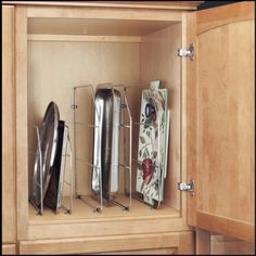 an open cabinet with various kitchen utensils in it