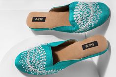 This Third Eye Hand Embroidered Mule is a luxurious pair featuring an ornate design with white embroidery. The opulent design makes these embroidered mules the perfect pair for housewarming parties! Sophisticated, timeless, and wholly feminine, these womens mules are simply the perfect finishing touch to any outfit. Each pair is completely handmade with fine materials and is comfortable enough to wear all day long.  The Fine Details:  1" Wedge Heel Slip-on Styling If you are in-between sizes, we Third Eye Hand, Embroidered Mules, Mules Heels, Beaded Shoes, Clogs And Mules, Ornate Design, Heel Mules, Women's Mules