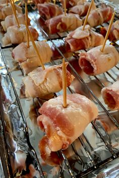 several skewered meats are being cooked on the grill with toothpicks